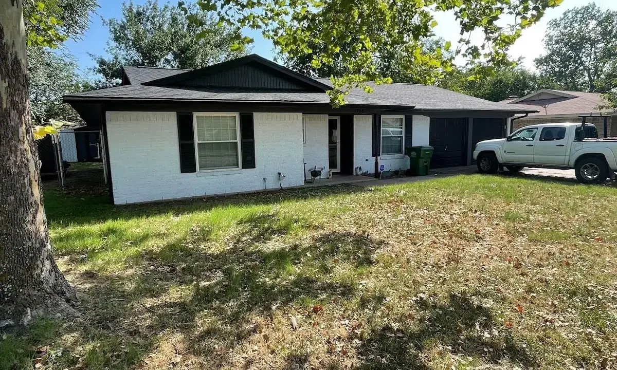 Professional roofing crew working on a residential roof in Fairview
